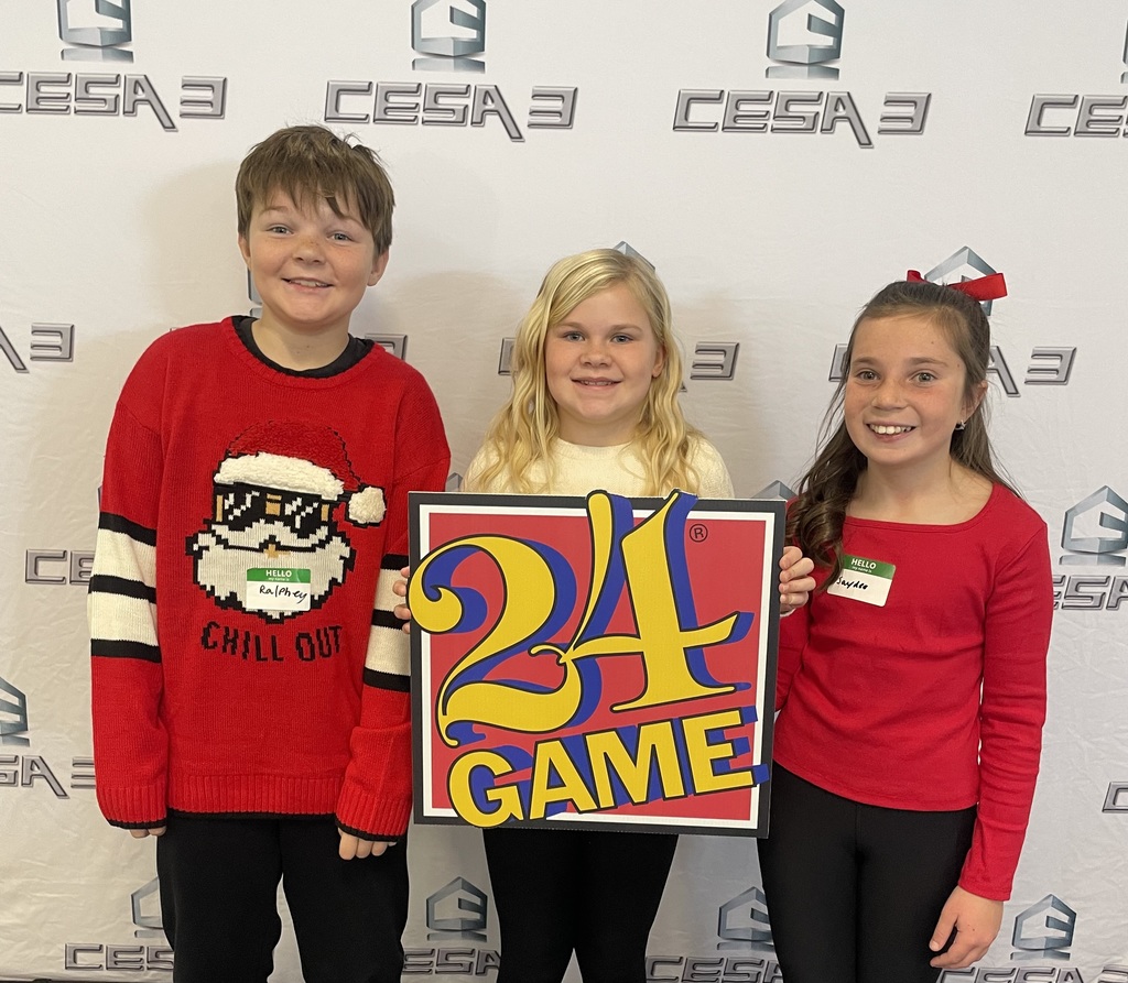 Students at the math 24 competition pose for a picture with the math 24 sign