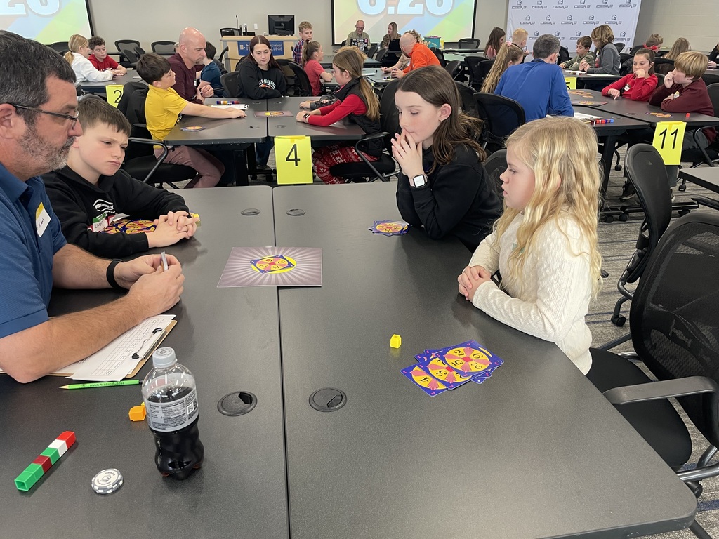 students sitting at a table competing in a math 24 competition