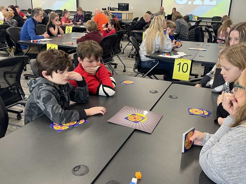 students sitting at a table competing in a math 24 competition