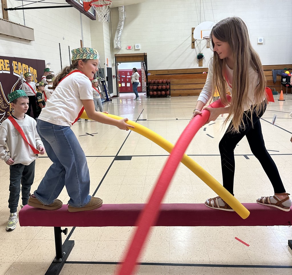 students doing jousting with pool noodles
