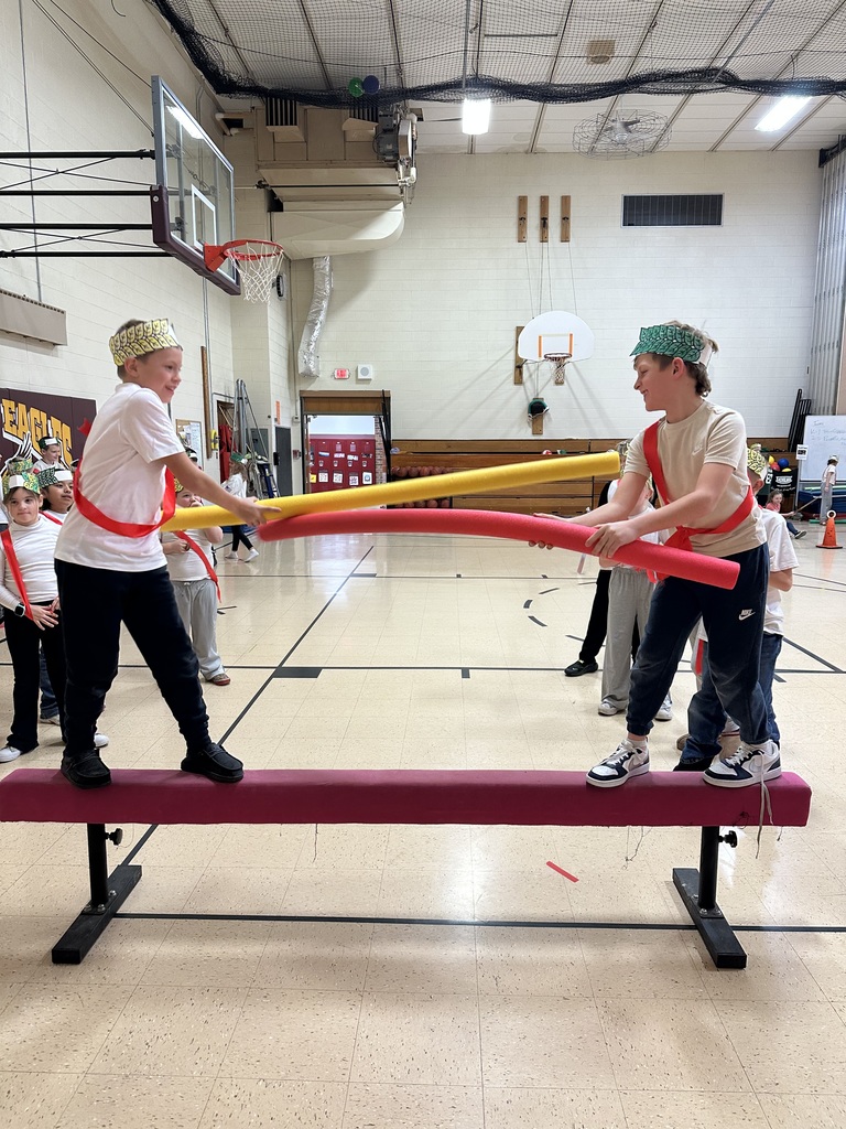 students doing jousting with pool noodles in the gym