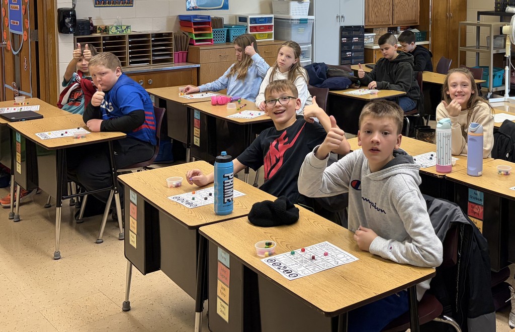 students sit at desks with their bingo cards