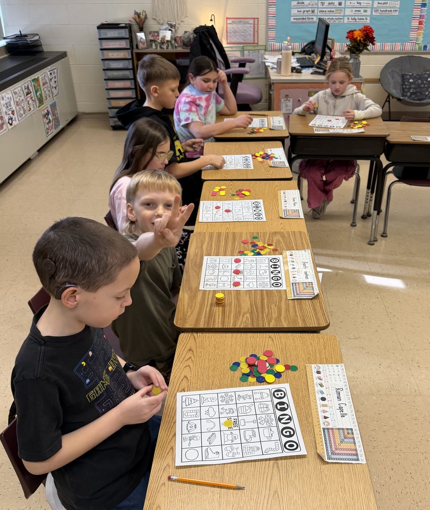 students sit at desks with their bingo cards