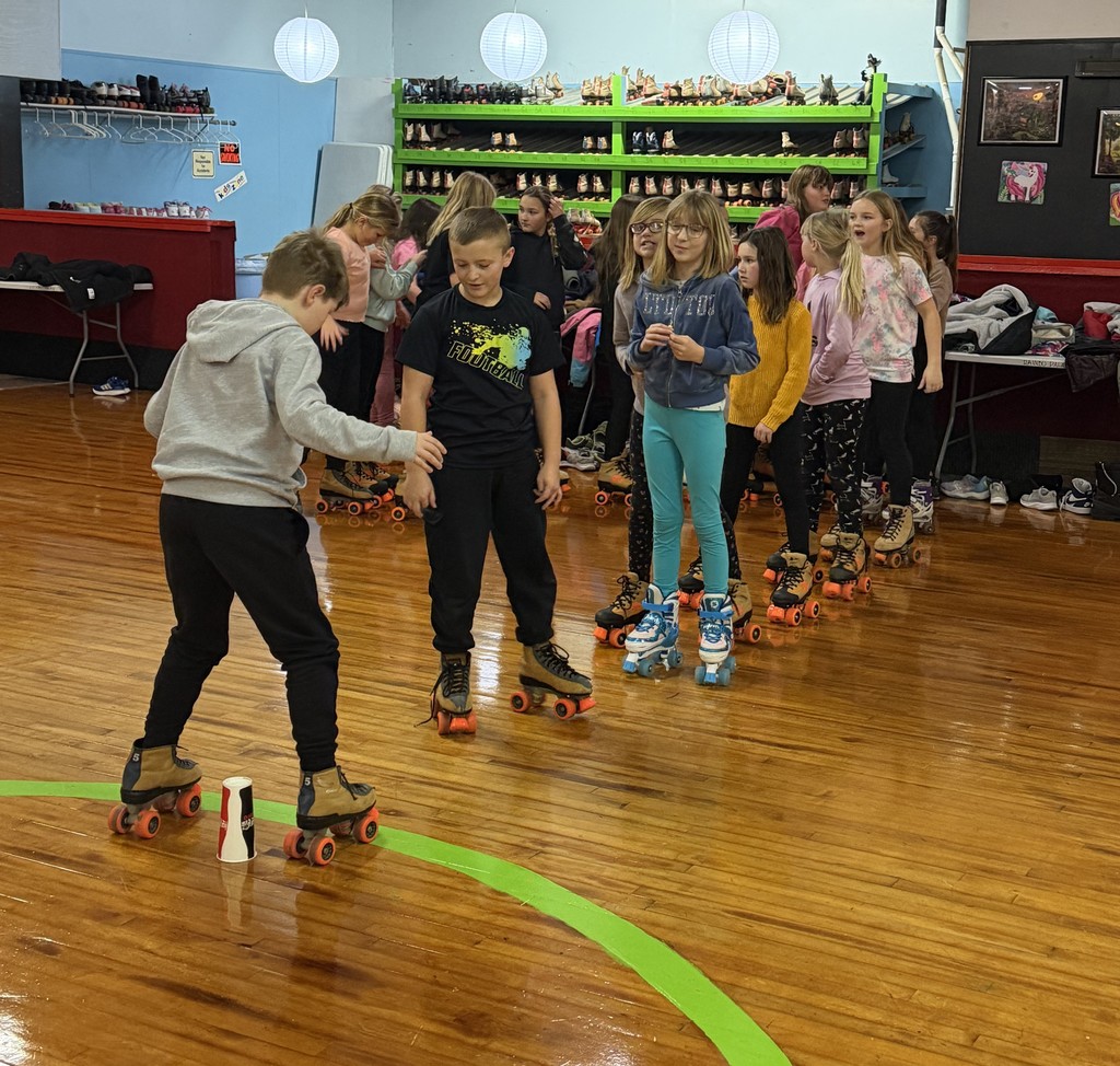 student skate at the rink around a paper cup