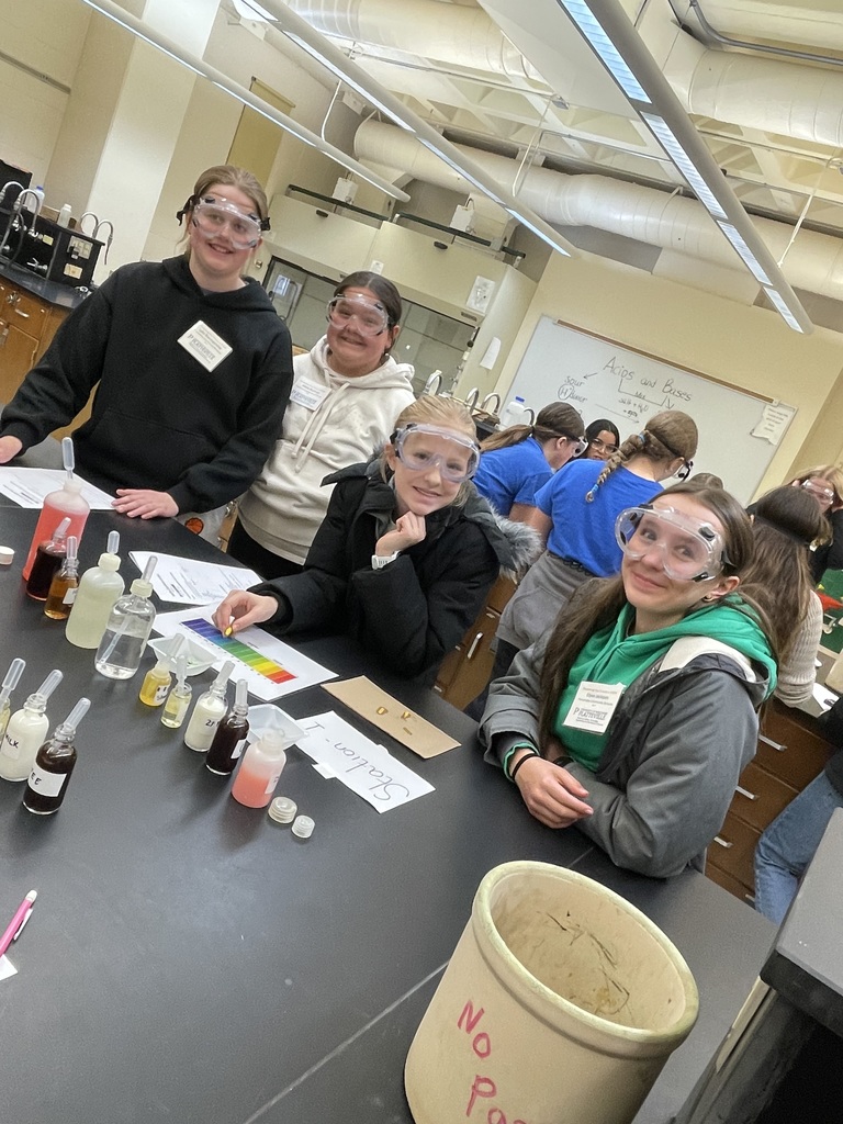 fifth and 7th grade girls at the women in STEM day at UWP  with goggles on doing an experiment