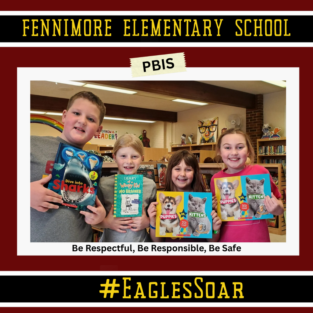 4 students holding up a book they got from book vending machine for trading in 20 eagle wings