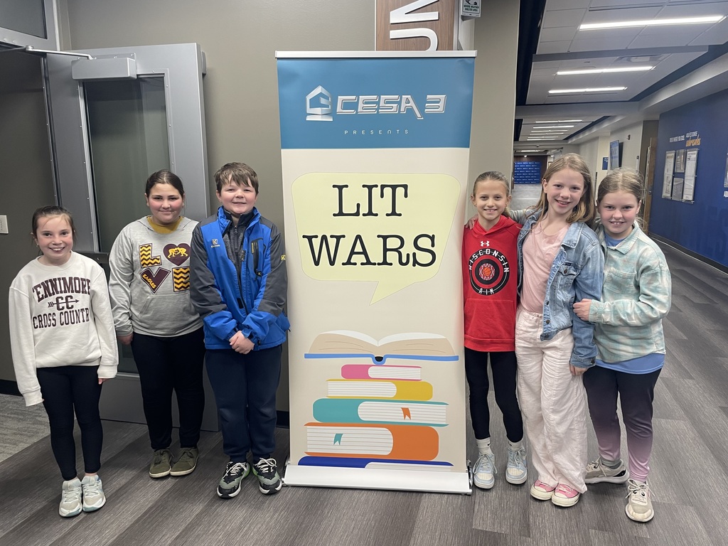students stand in front of the lit wars sign at the competition