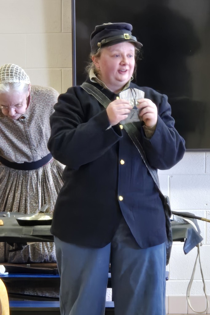 The civil war speaker talks with the fourth grade students