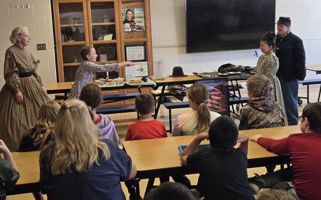 some students dressed in civil war garb demonstrate how to play a gmae