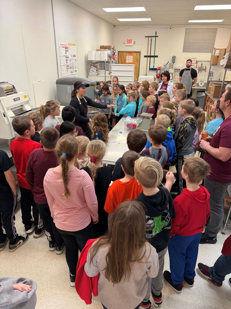3rd grade students listen to the owner at Papa Murphys pizza