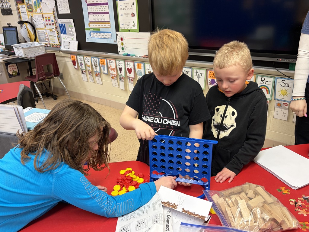 student play a game at a desk on family night