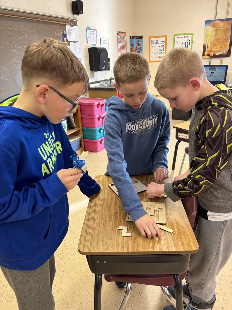 student play a game at a desk on family night