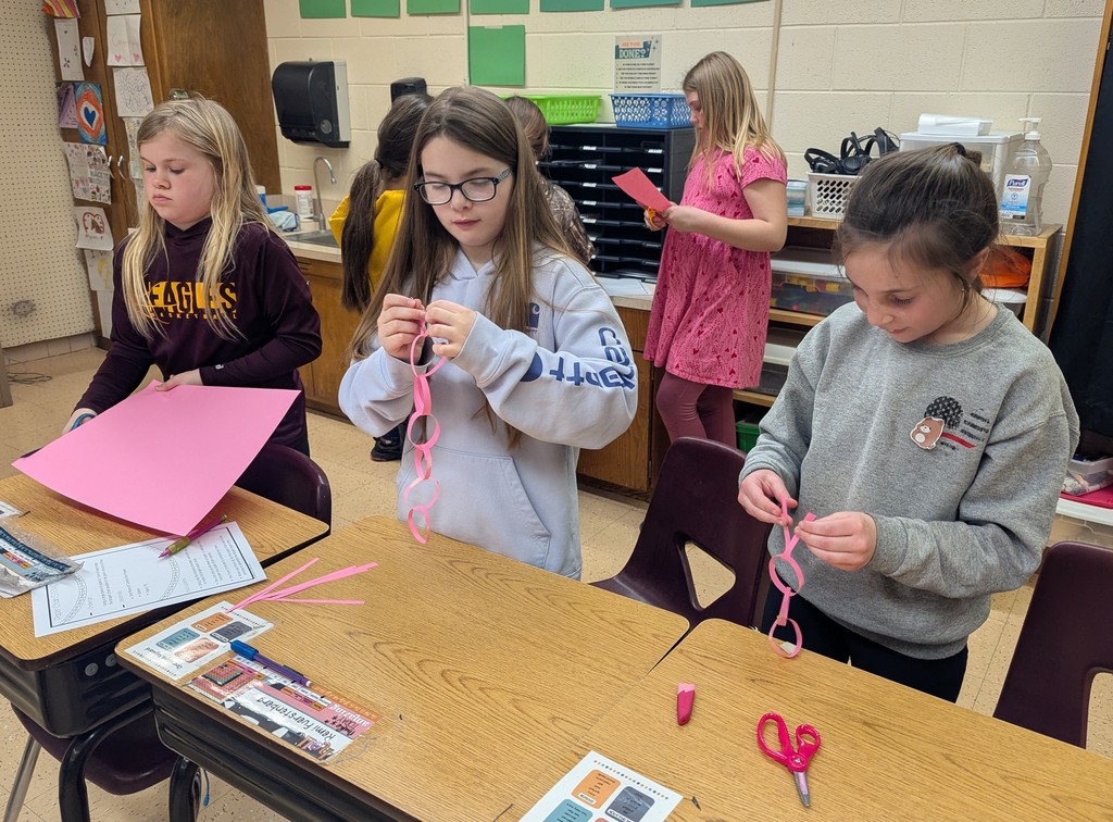 students work together to make paper chains