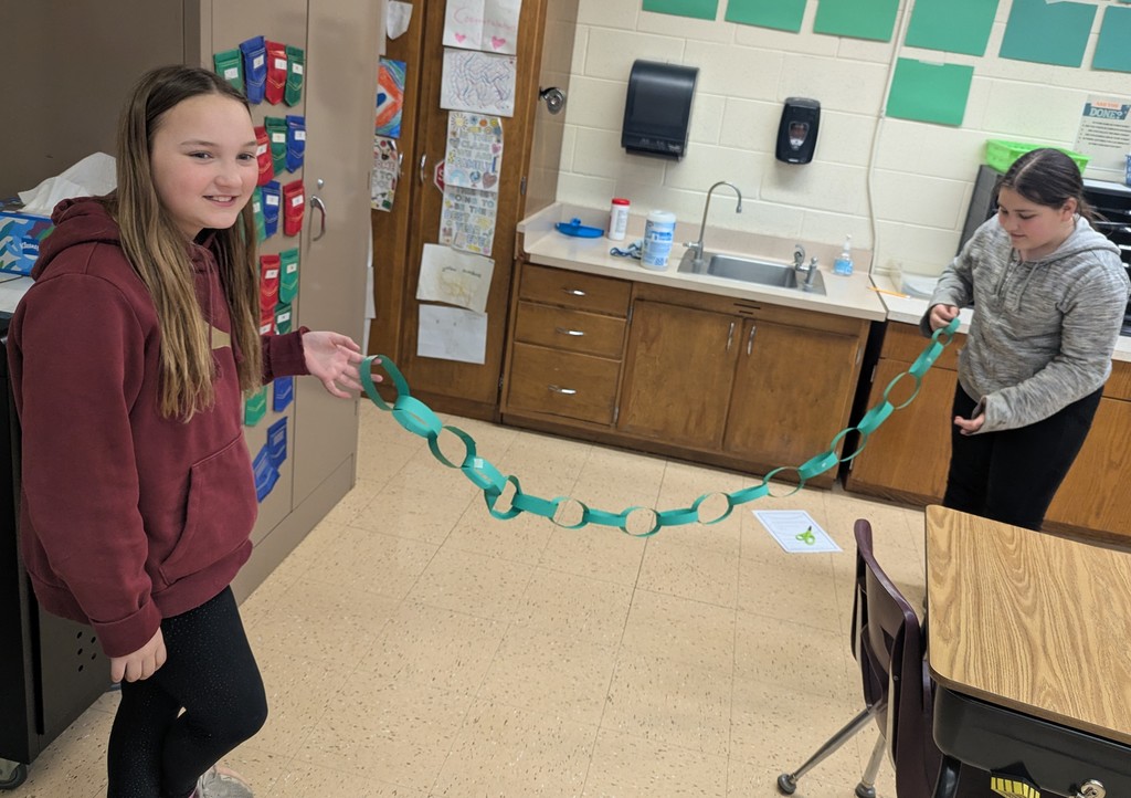 students work together to make paper chains