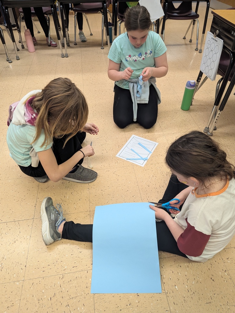students work together to make paper chains