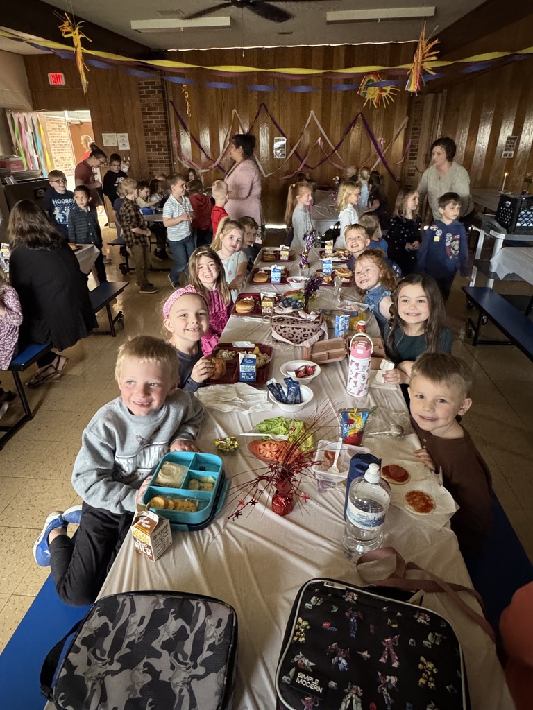 students enjoy the formal dinner at the elementary school