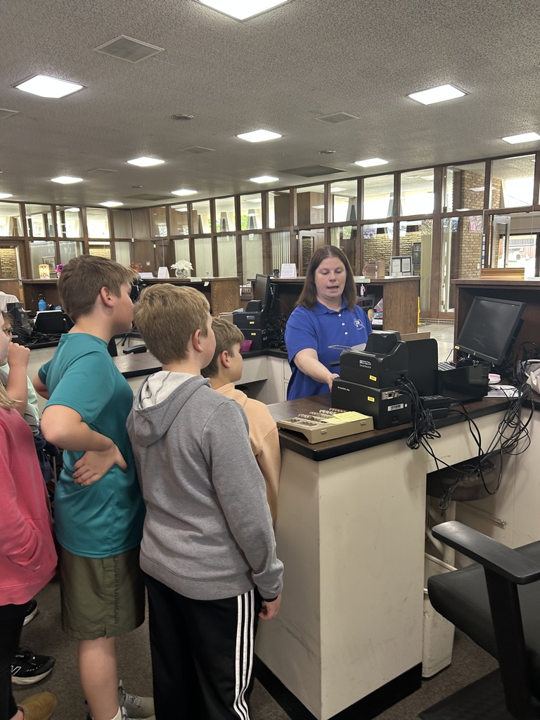 students listen to the bank worker on the tour