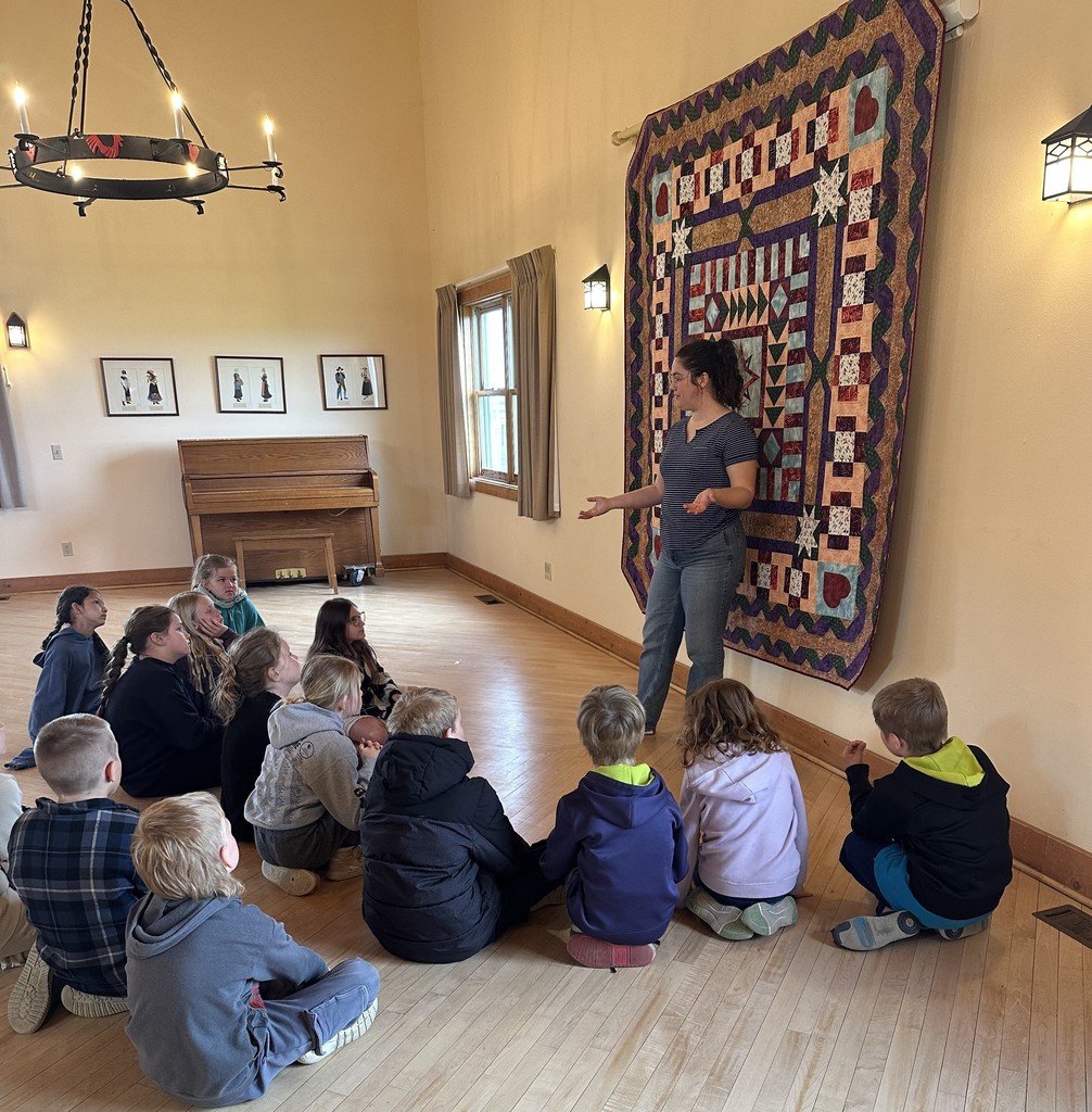students listen to a worker from Folklore village