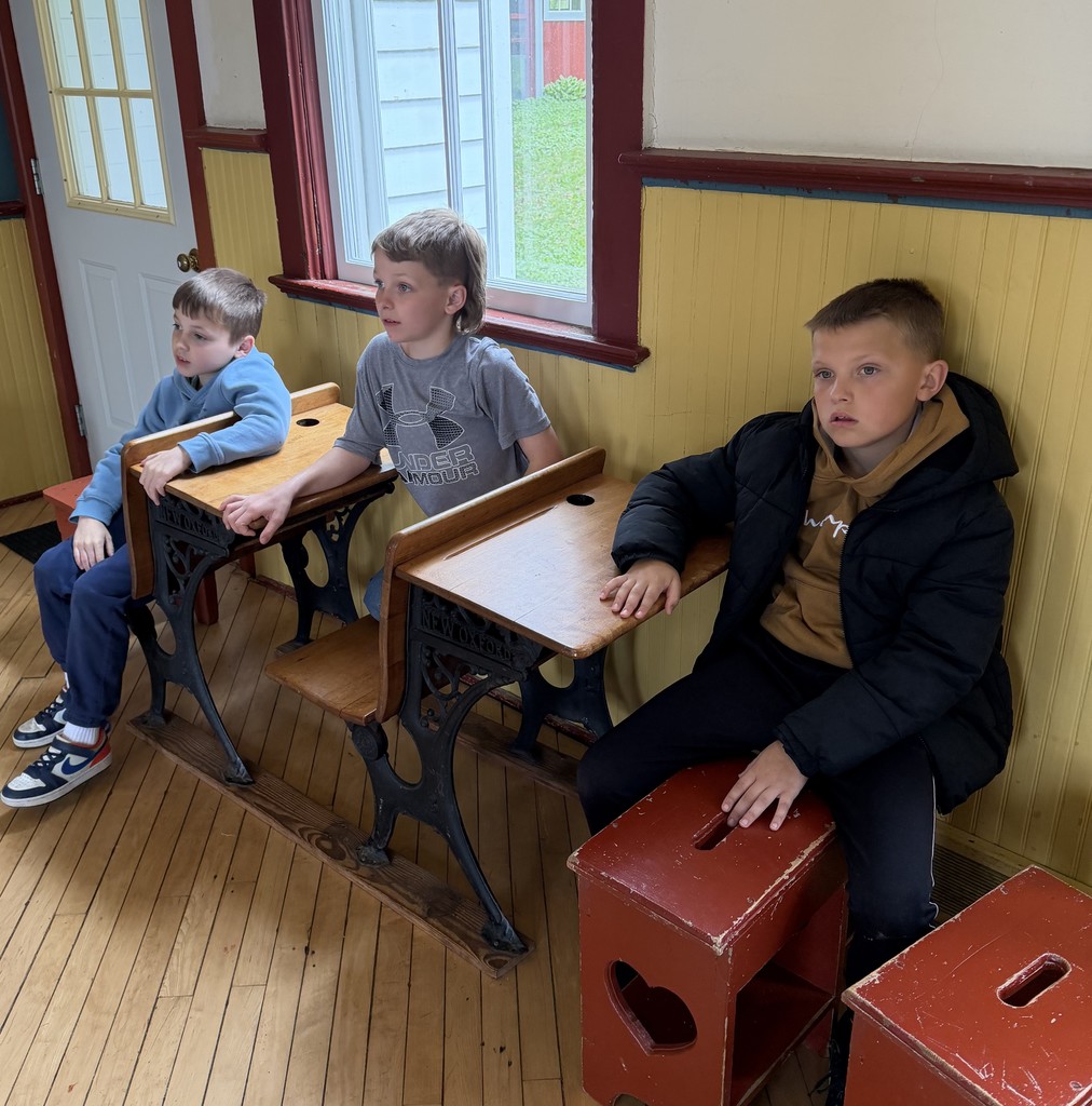 students listen at a one room schoolhouse