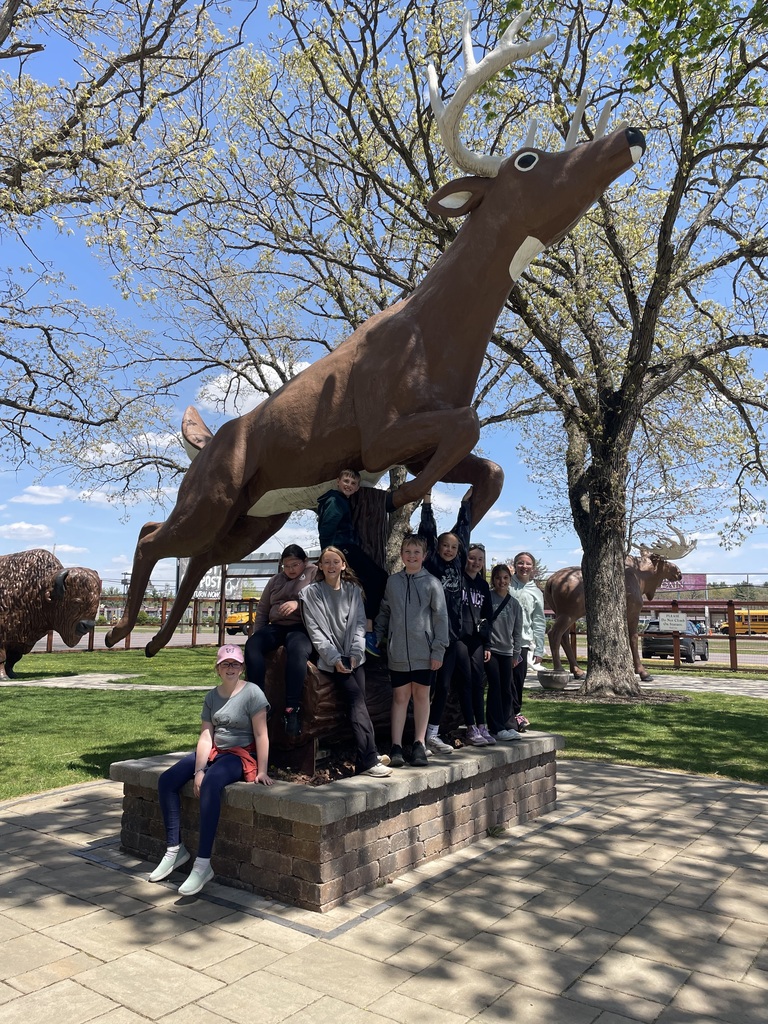 members of safety patrol by large deer statue
