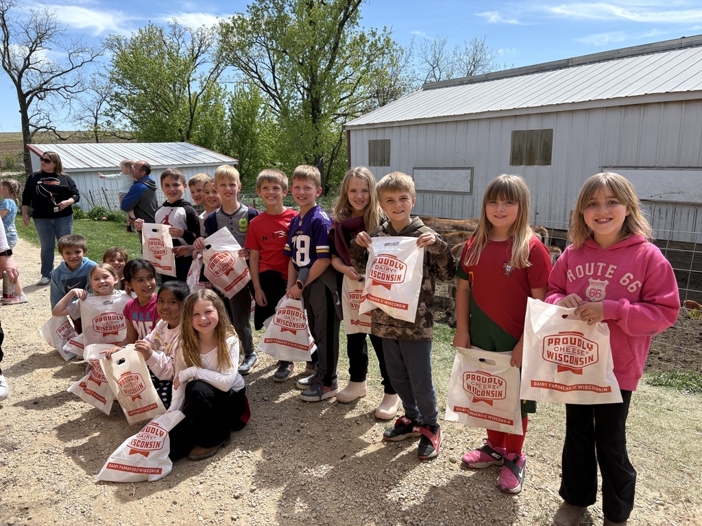 students hold up bags they got at the farm