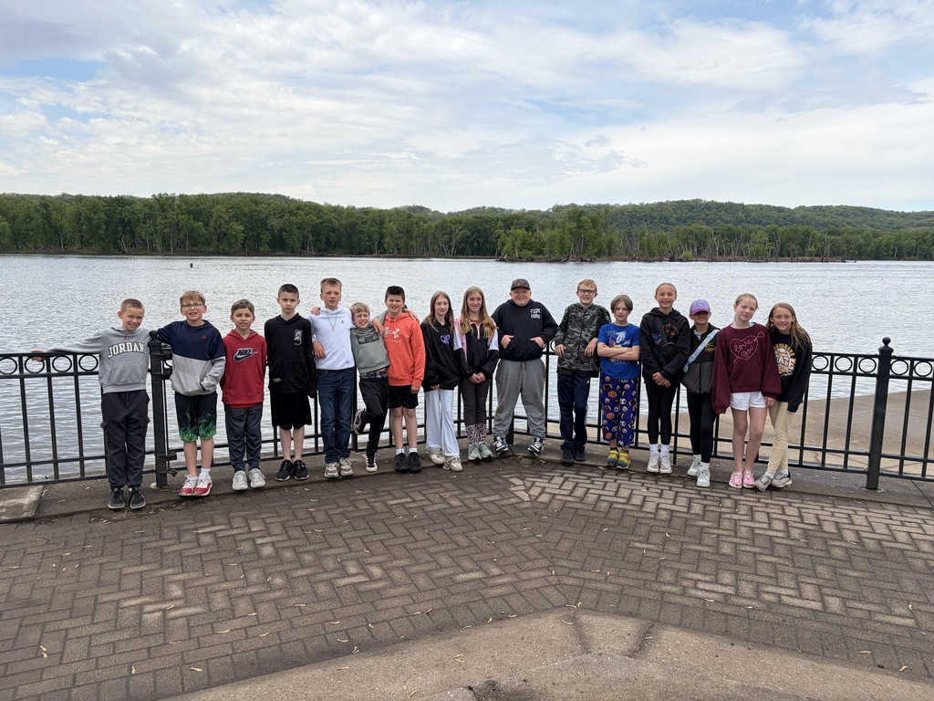students pose for a picture with the Mississippi river in the background