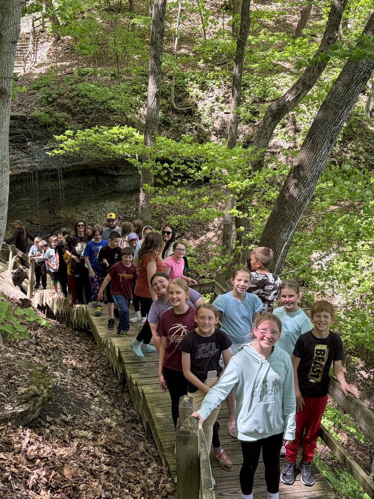 students hike to a water fall on their field trip