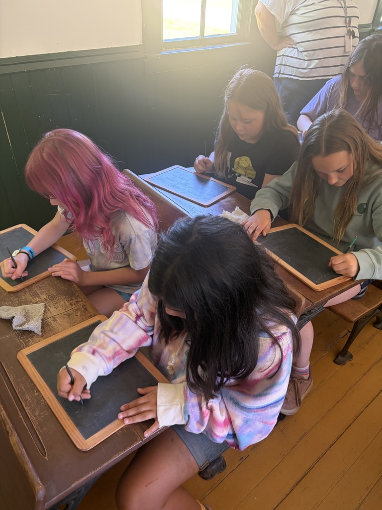 students take a spelling test in the one room schoolhouse at Stonefield