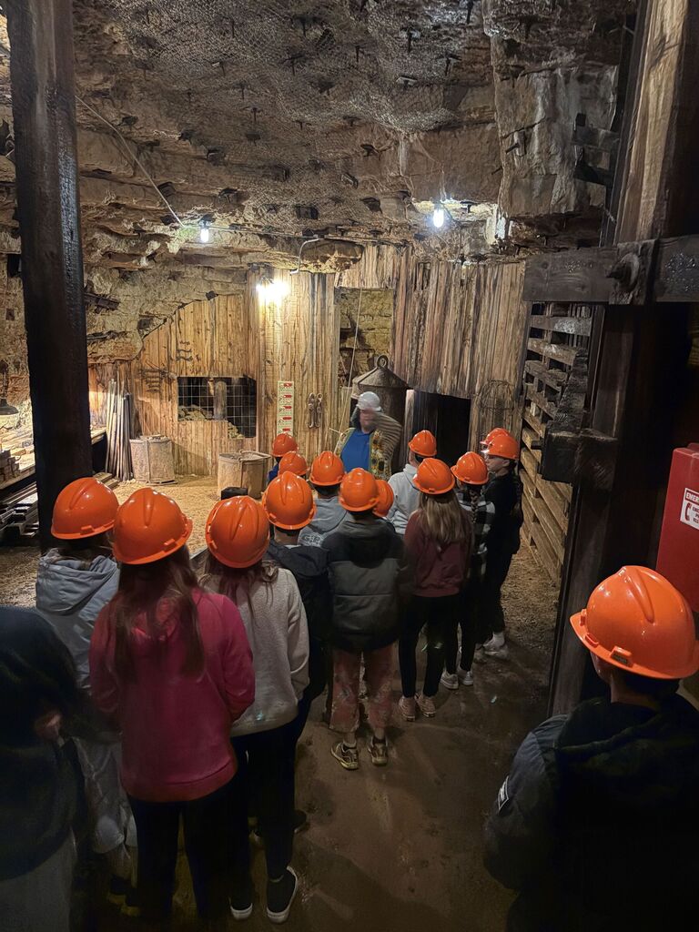 students listen on the tour down into the mine at the museum