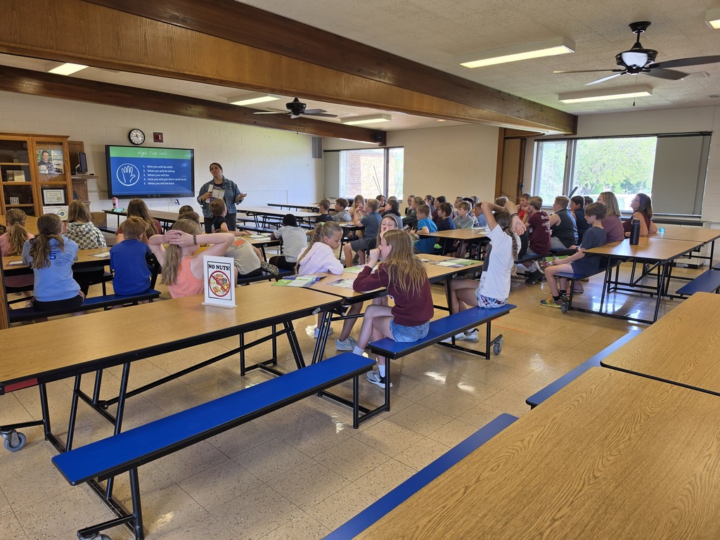 students listen to a speaker from Emplify Health talk about being safe at home