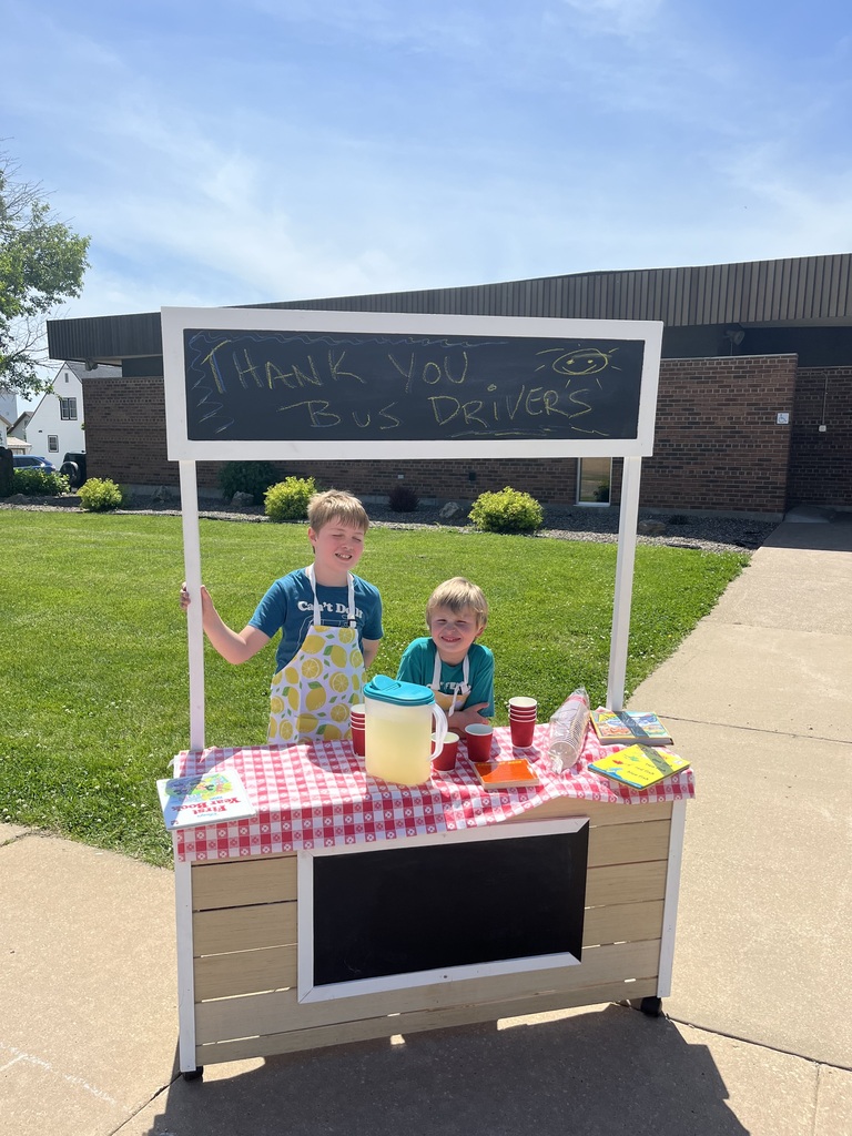 students set up a lemonade stand to give a cold class of lemonade to each bus driver