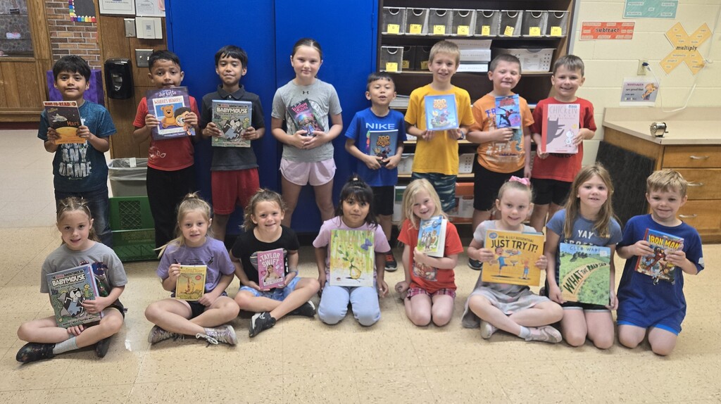 student show off their new books for a picture