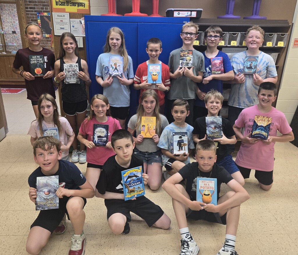 student show off their new books for a picture
