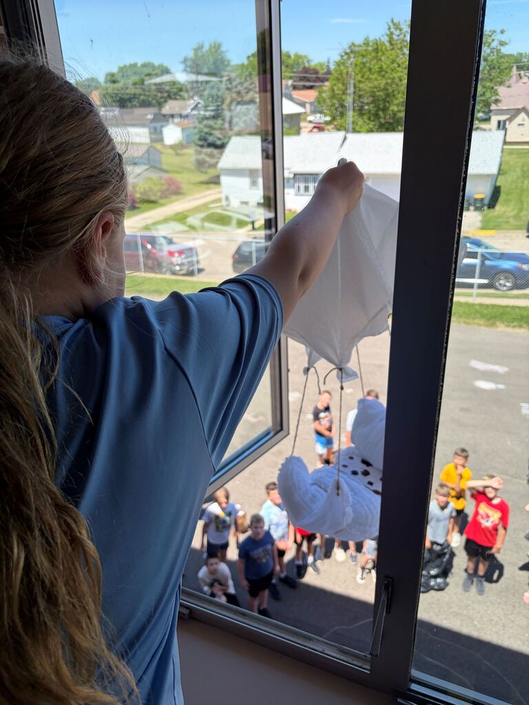 Student drops their contraption from 2nd floor of building as kids below watch