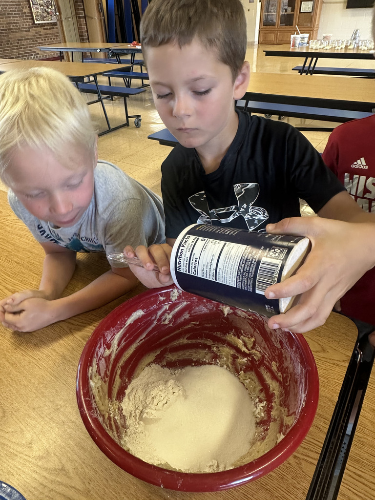 student mixing dough