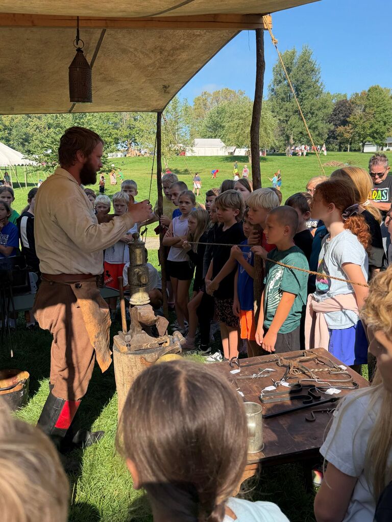 students listen to a speaker at the encampment