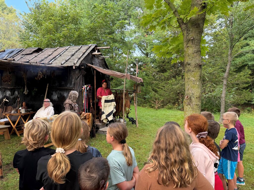 students listen to a speaker at the encampment