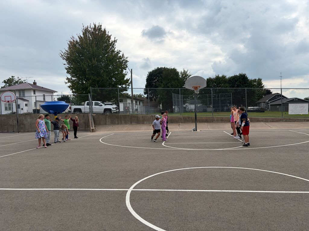 5th grade students play human chain game outside