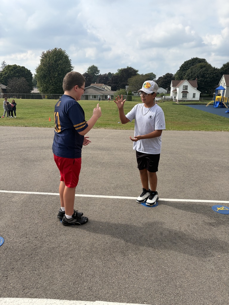 students play rock paper scissors