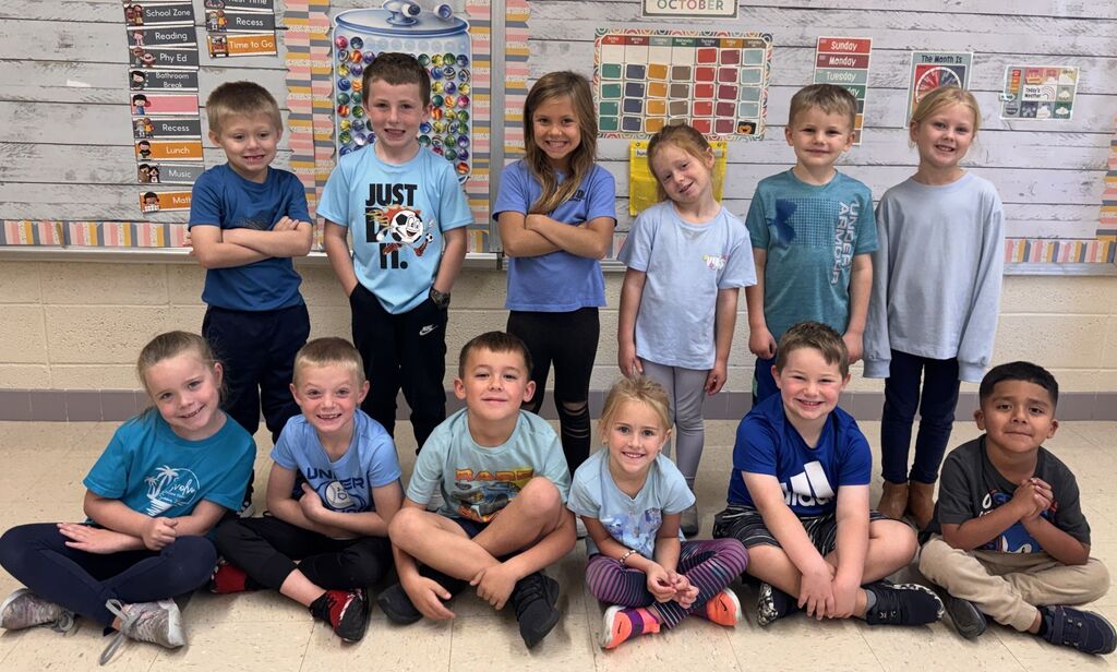 students that are wearing blue take a picture