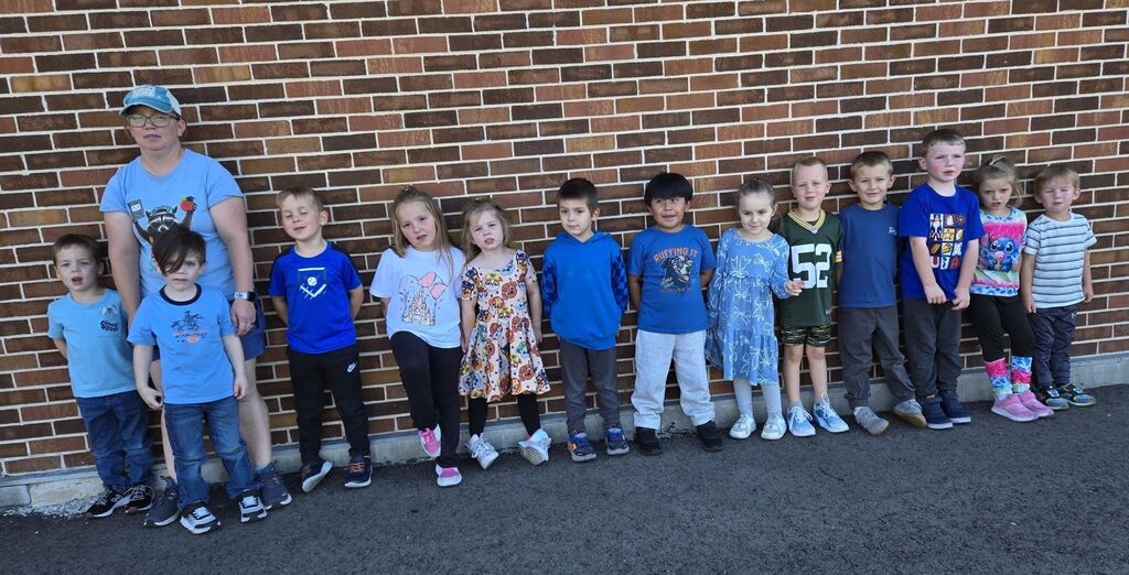 students that are wearing blue take a picture