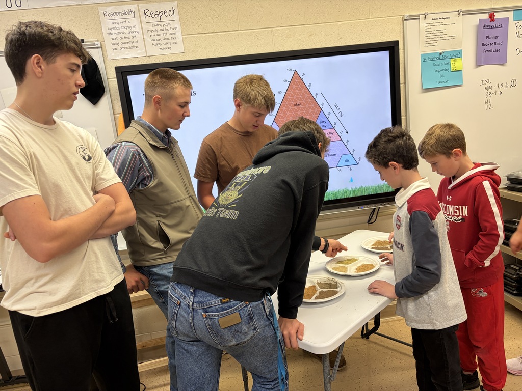soil team members from FHS FFA show different soil samples to students