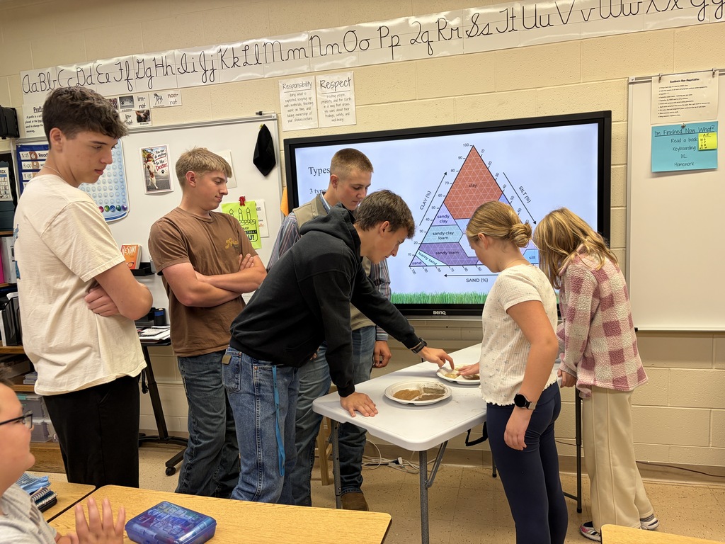 soil team members from FHS FFA show different soil samples to students