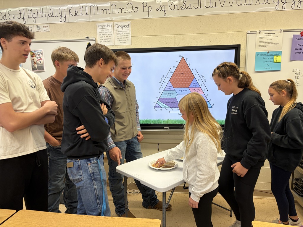 soil team members from FHS FFA show different soil samples to students