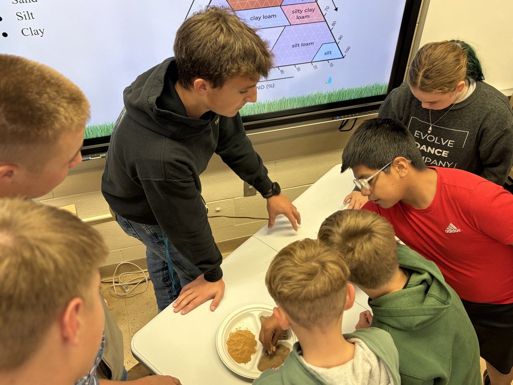 soil team members from FHS FFA show different soil samples to students