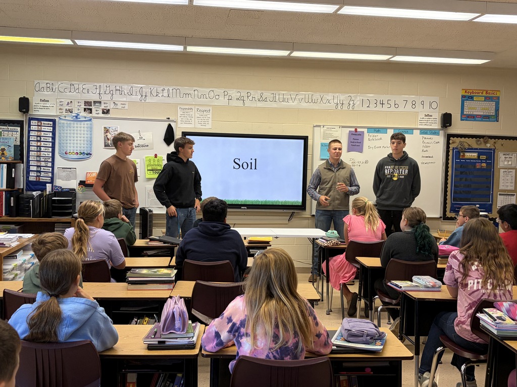 soil team members from FHS FFA show different soil samples to students