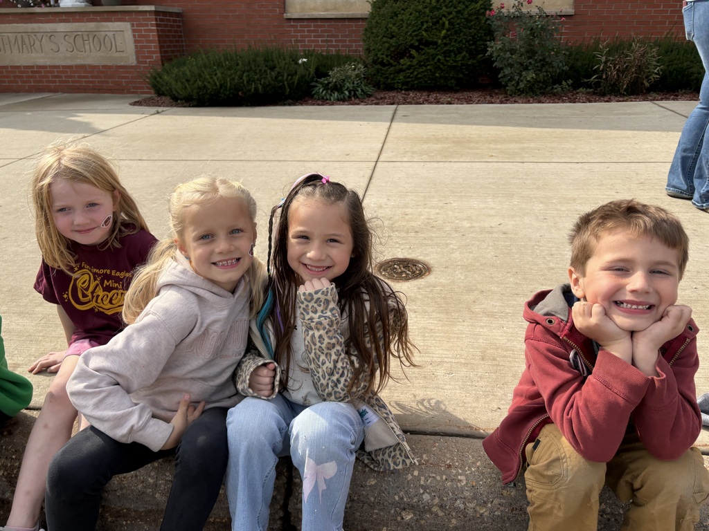 students sit and watch the parade