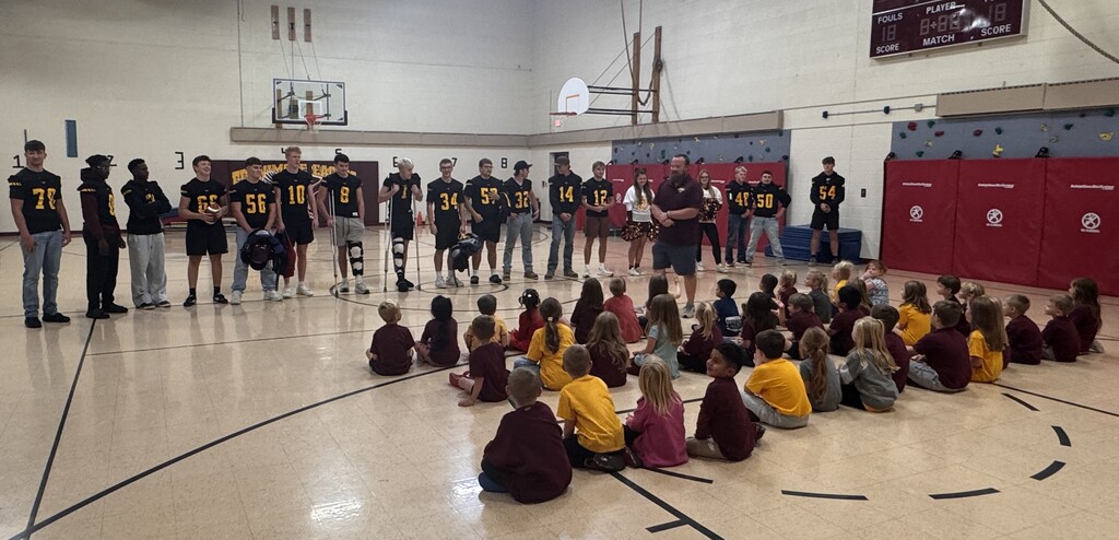 the football team and coaches talk with the 5K friends.