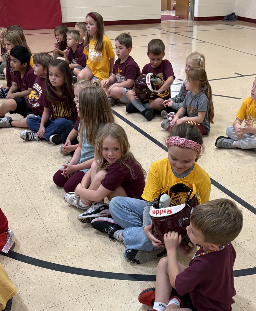 students check out a players helmet