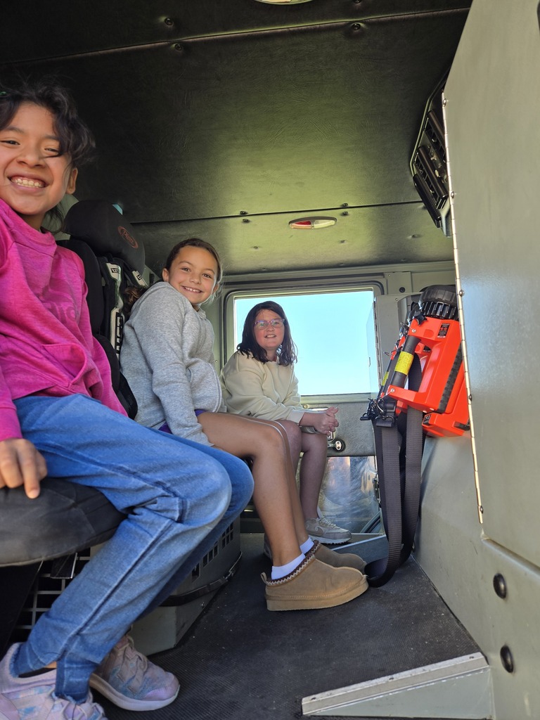 students sit in a fire truck